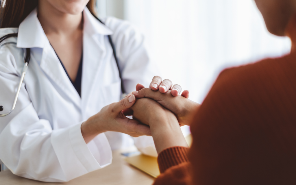 Doctor holding patients hand