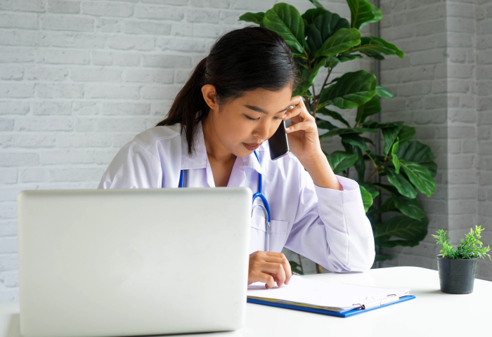 Doctor on the phone to patient via telehealth