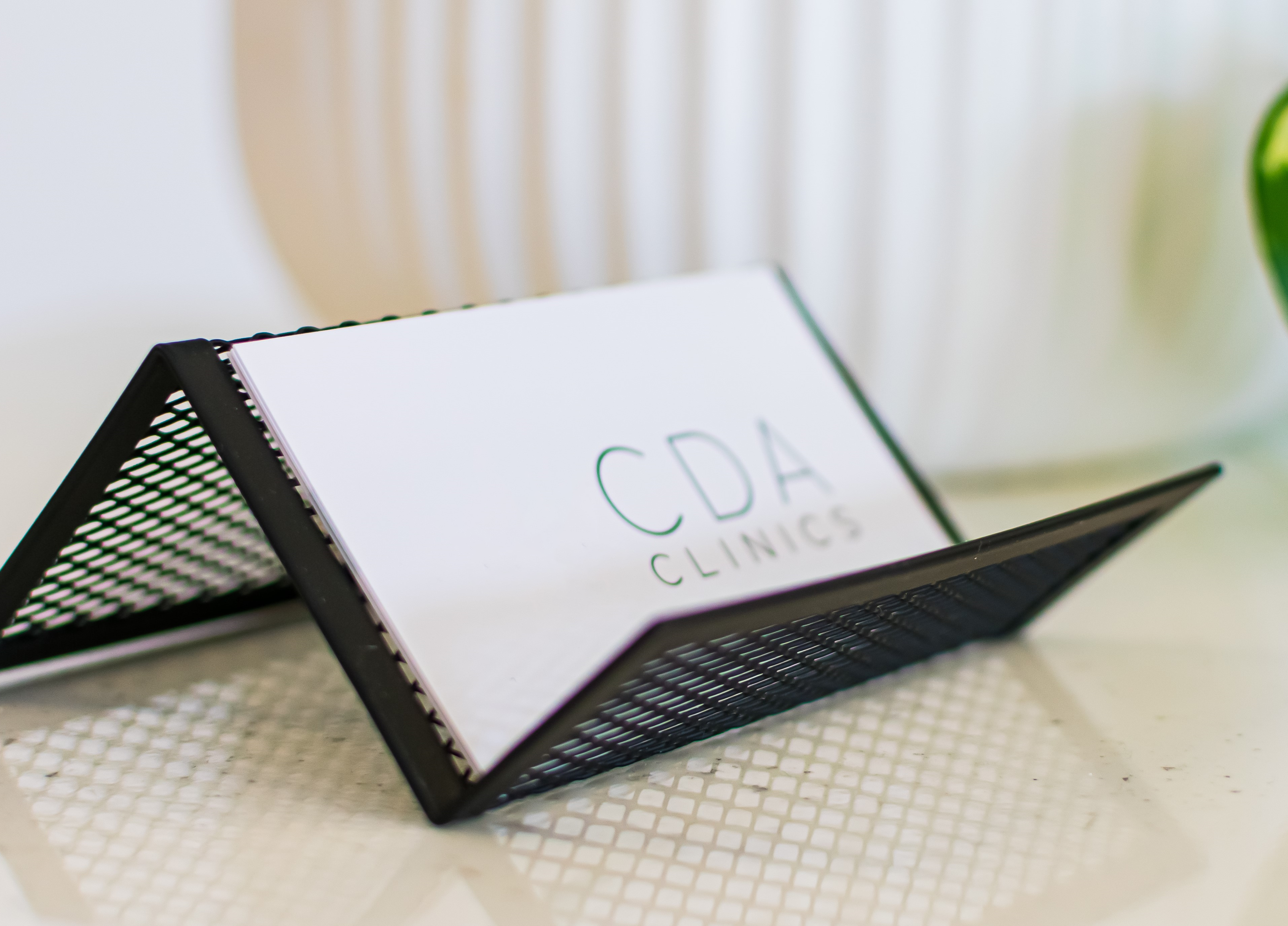 Cannabis Doctors Australia business card in a cardholder on a desk